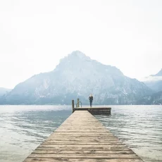 woman-standing-alone-on-a-large-wooden-p